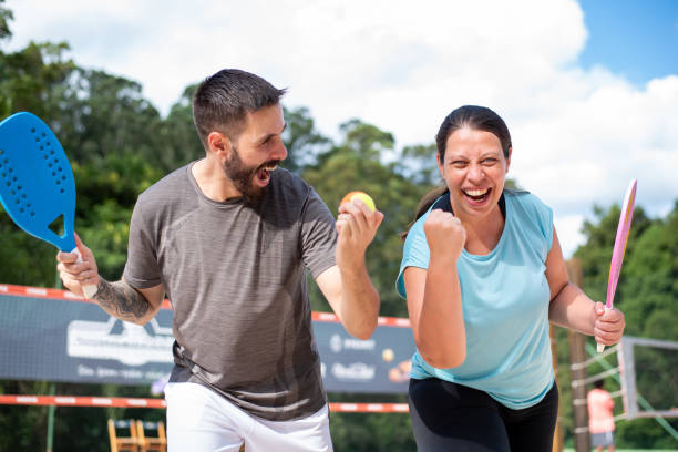 istock Couple playing beach tennis 1388234234
