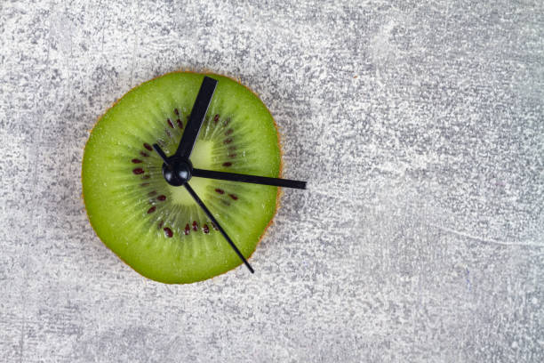 istock A clock made of green kiwi fruit shows the time 1388234436
