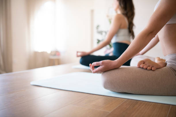 istock Young women meditating at yoga class. 1388235191