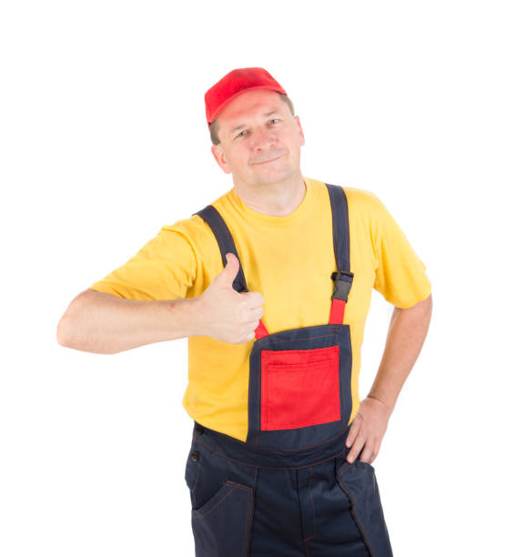 istock A worker in overalls gives a thumbs up. 1388235217