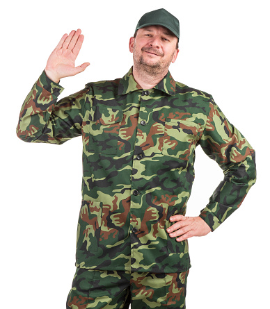 A man in a camouflage combat jacket raises his hand in greeting. Isolated on a white background. Close-up.