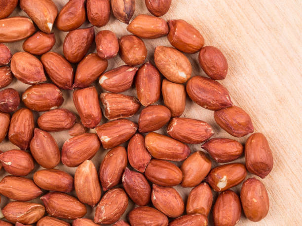 istock Peanuts are located on a wooden surface. 1388235769