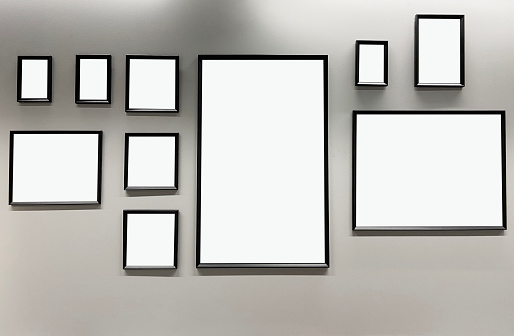 Group of different size picture frames hanging on the wall with clipping path