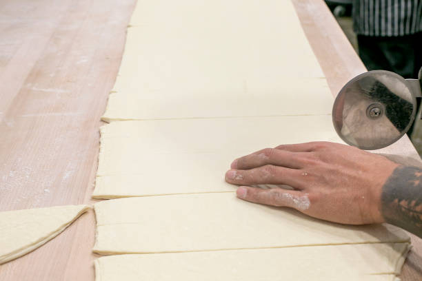 istock Chef Cutting Dough to Make Croissants 1388240463