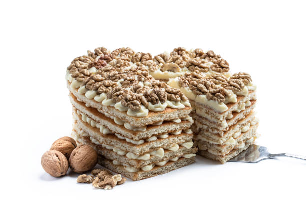 Homemade  Heart shaped layered cake decorated with walnuts isolated on white