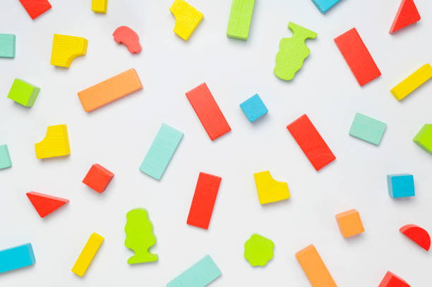 istock Multi-colored children's constructor made of natural wood on light gray background flat lay top view. Colored children's bricks for construction. Building blocks background. Developing toys, game 1388240829