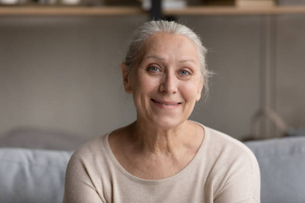 istock Smiling grey haired elder 70s lady head shot portrait 1388244178