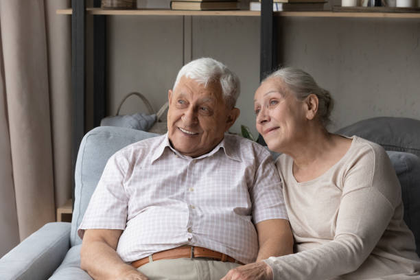 istock Happy thoughtful older 80s 70s couple relaxing on couch 1388244210