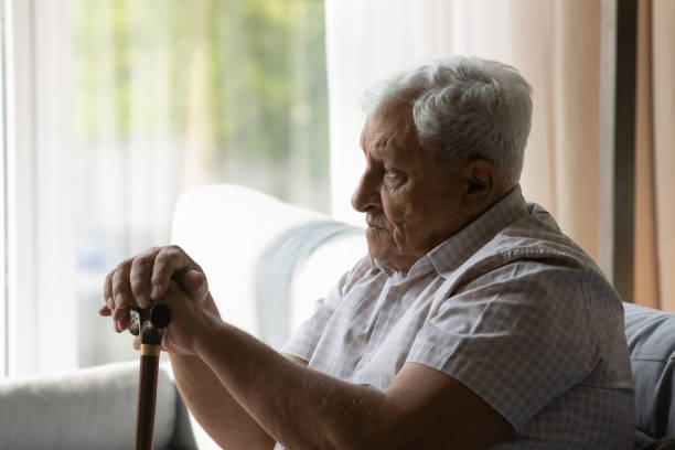 istock Sad depressed older 80s man holding gimp stick knob 1388244249