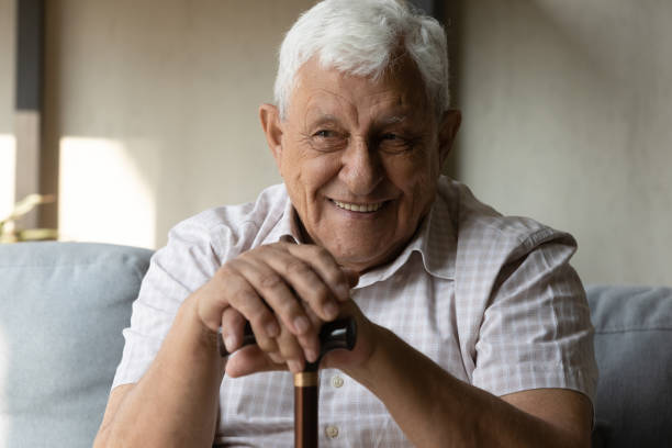 istock Happy elder 80s man with disability holding knob of cane 1388244251