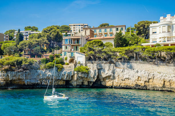 Holiday apartment buildings along the coast of Cassis Holiday apartment buildings along the coast of Cassis on a summer day in Provence, France casis stock pictures, royalty-free photos & images