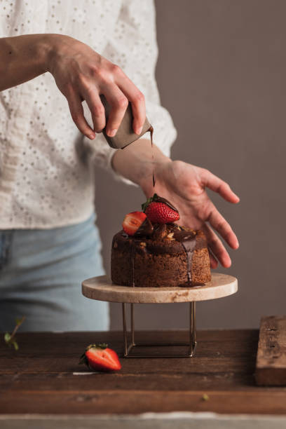 istock Female hands decoration banana bread 1388245422