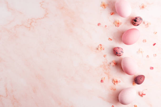 istock Easter eggs border and hydrangea flowers on pink marble background. 1388245810