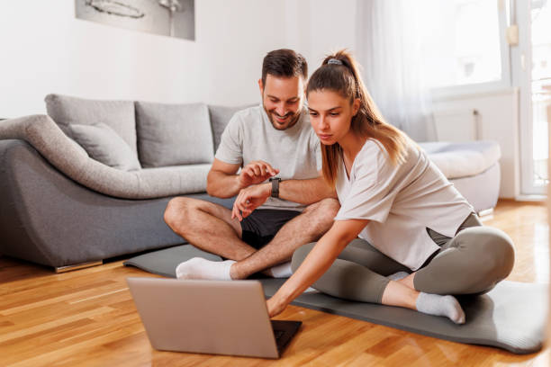 pareja preparándose para el entrenamiento en línea en casa - stretching boyfriend indoors lifestyles fotografías e imágenes de stock