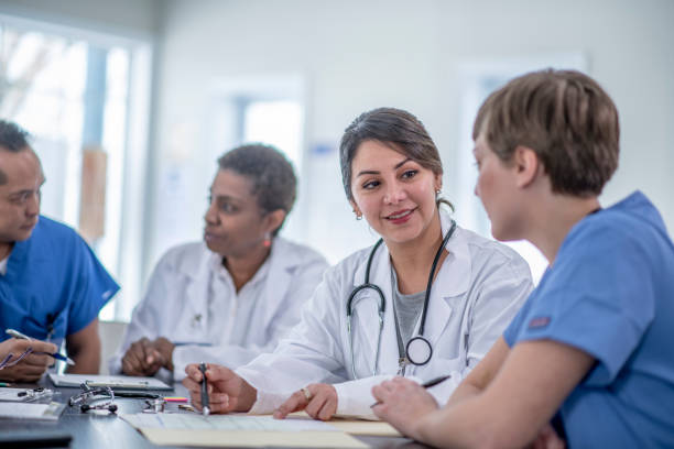istock Two Female Doctors Talking During a Meeting 1388250883