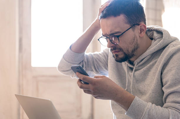 istock A man with glasses uses a smartphone, copy space. 1388251922