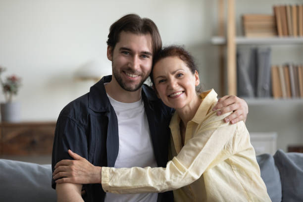 istock Happy middle aged mother and grown son hugging with affection 1388253746