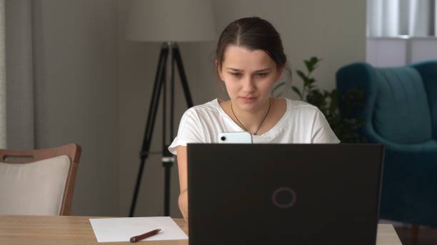 istock Authentic Stressful Woman working Chatting On Laptop Living Room. Writing Searching Using IT. Tired Sad Lady Working On Computer Internet On Comfortale Chair. Buisenes, Education, Technology Concept 1388254184
