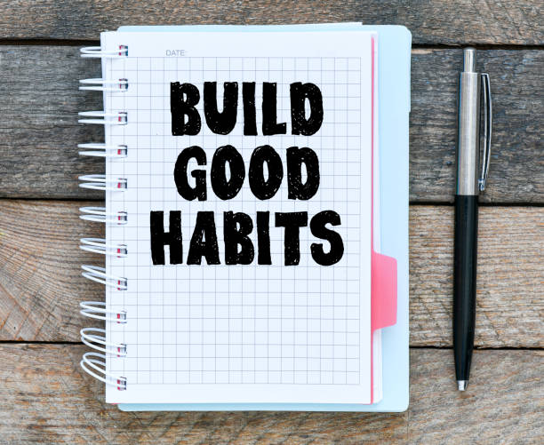 istock Build good habits symbol. Words written in the office notebook. 1388254327