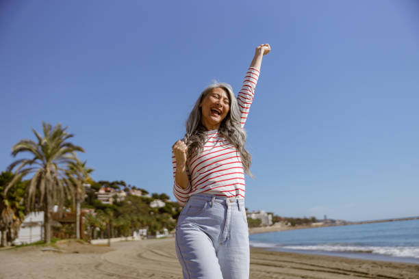istock Healthy inspired female walking outdoors along seashore 1388254458