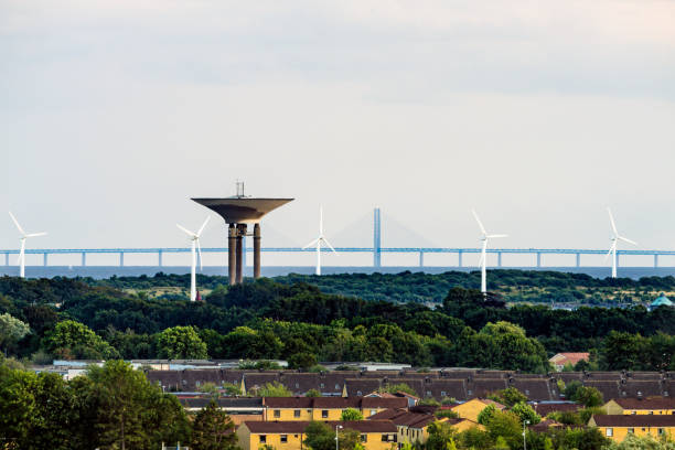The Oresund bridge with Landskrona water tower in the foreground. The Oresund Bridge is a combined motorway and railway bridge between Sweden and Denmark (Malmo and Copenhagen). Photo is taken from Landskrona in Sweden. oresund bridge stock pictures, royalty-free photos & images