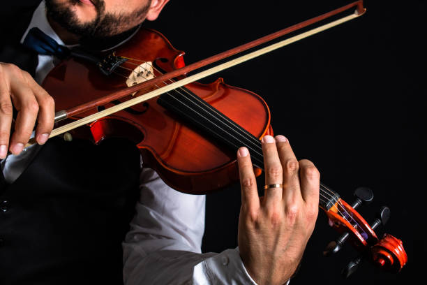 istock Elegant man playing classical music with his violin 1388259564
