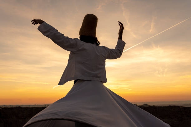 sunset and whirling at the sea, sufi. sufi whirling (Turkish: Semazen) is a form of Sama or physically active meditation which originated among Sufis. stock photo