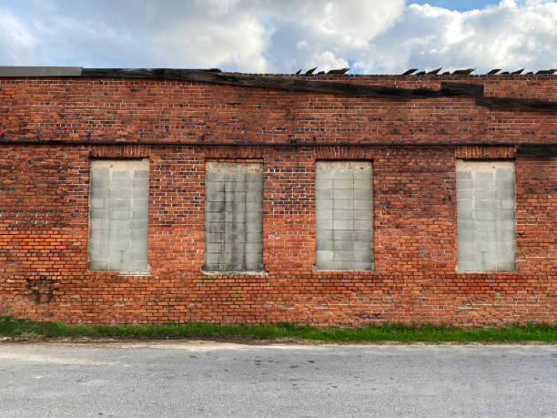 istock closed small town factory warehouse abandoned building red brick wall empty desolate disaster area 1388262749
