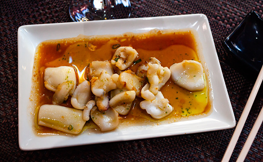 Tasty dish of japanese cuisine fried sepia in sauce, nobody