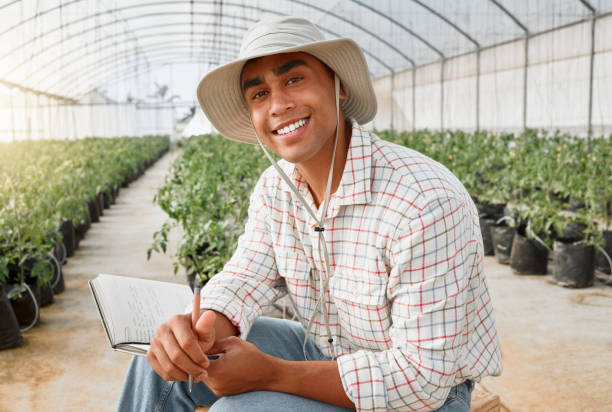 istock Portrait of a young man writing notes while working in a greenhouse on a farm 1388265781