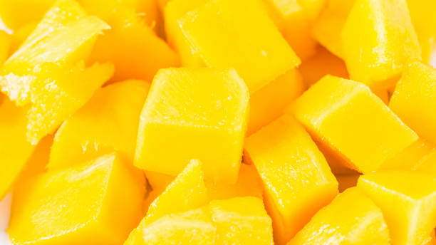 istock plate with pieces of mango on the table, close-up 1388266816