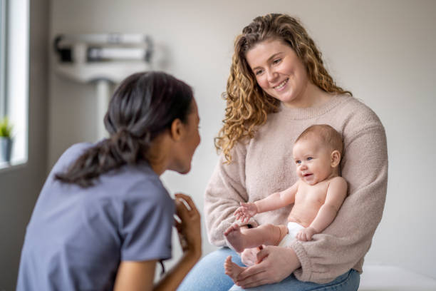 istock Nurse Talking with a New Mother 1388268554