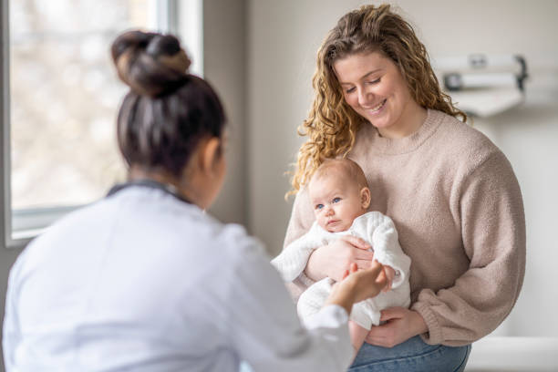 istock Baby Holding a Doctors Finger 1388268559