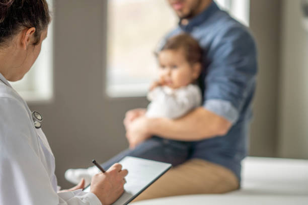 istock Father and Daughter at the Doctors 1388268575