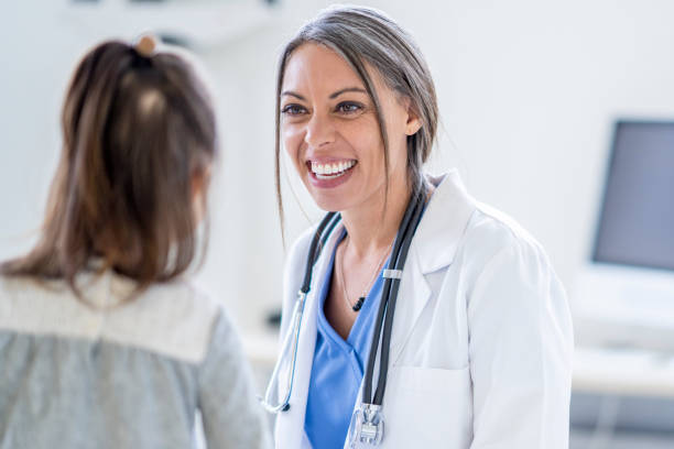 istock Female Doctor with a Young Patient 1388268586