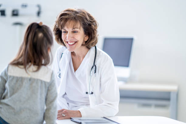 istock Female Doctor with a Young Patient 1388268599