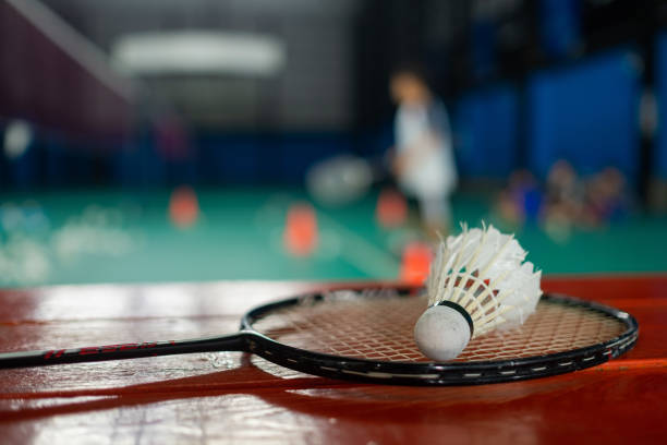 istock Badminton shuttlecock and racket with blur player background 1388270880
