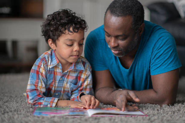 istock Father and Son Reading Together 1388271146