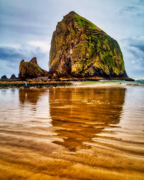 Sky and Haystack Rock reflections on Cannon Beach
