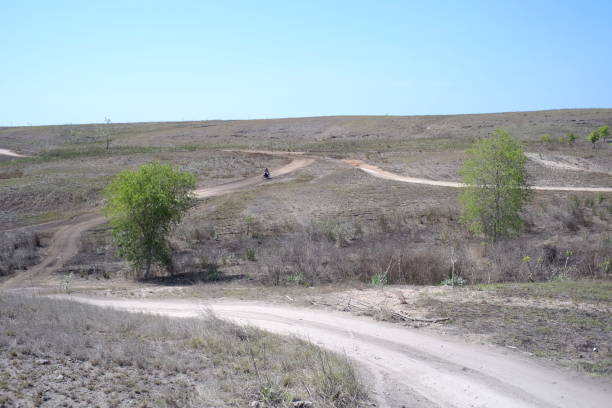 istock A dusty dirt road that cuts through dry field land 1388274972