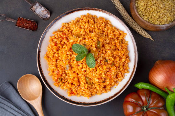 istock Traditional turkish bulgur pilaf with tomato sause in plate (Turkish name; meyhane pilavi) 1388277914