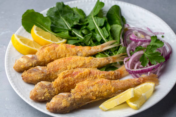 istock Plate of fried small fish red mullet and lemon 1388277944