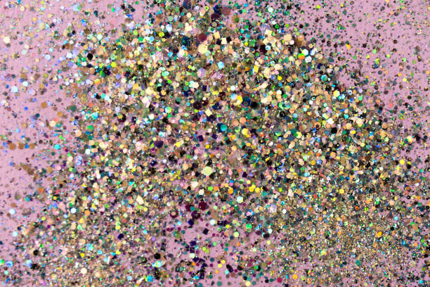 istock Flying silver holographic confetti on pastel pink background. Festive concept. 1388281775