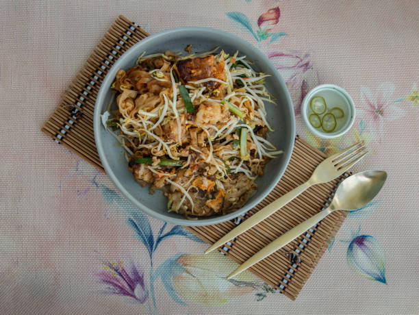 Fried Thai Noodle (pad thai) mix Stirred fried turnip cake or Fried radish cake (chai tow kway) with bean sprout and chives.