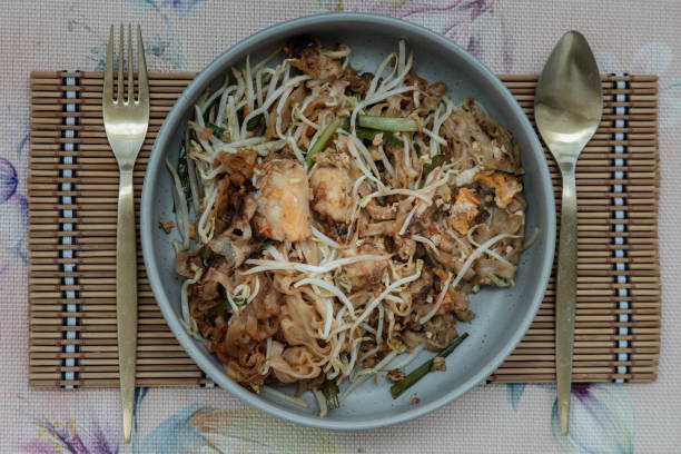 istock Fried Thai Noodle (pad thai) mix Stirred fried turnip cake or Fried radish cake (chai tow kway) with bean sprout and chives. 1388282043