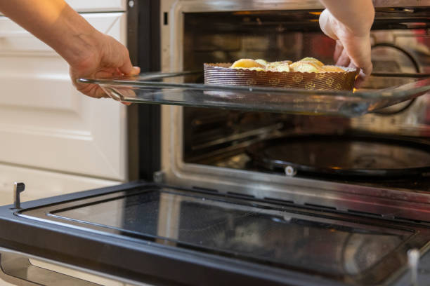 istock Cooking an apple pie. Putting the pie in the oven for baking. 1388282981