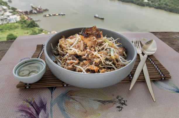 Fried Thai Noodle (pad thai) mix Stirred fried turnip cake or Fried radish cake (chai tow kway) with bean sprout and chives.