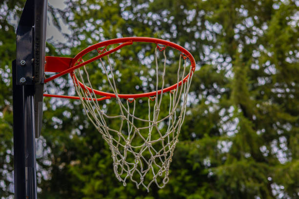 istock Basketball Hoop Sending Peaceful Vibe with Trees in Background 1388288675