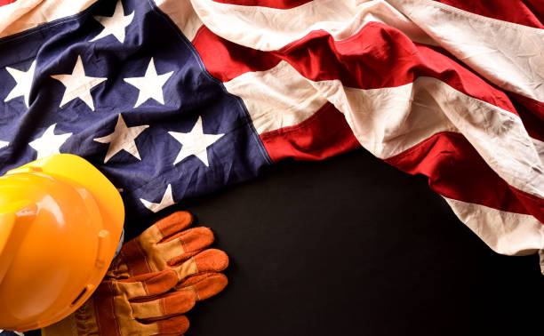 istock Happy Labor day concept. American flag with different construction tools on dark stone background. 1388289514