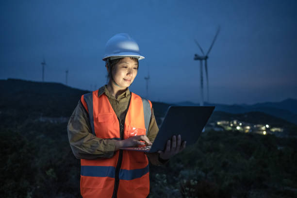 istock Female engineer checking equipment with laptop in hand at night 1388290416